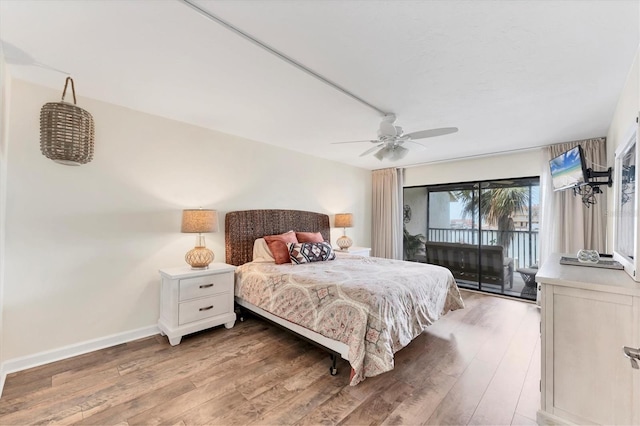 bedroom with a ceiling fan, access to outside, baseboards, and wood finished floors