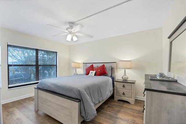 bedroom with ceiling fan, dark wood finished floors, and baseboards