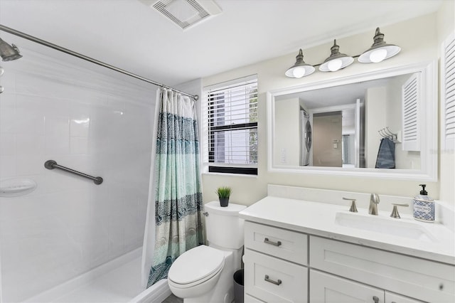 bathroom featuring visible vents, a tile shower, vanity, and toilet