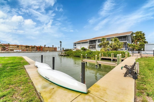 dock area with a yard and a water view