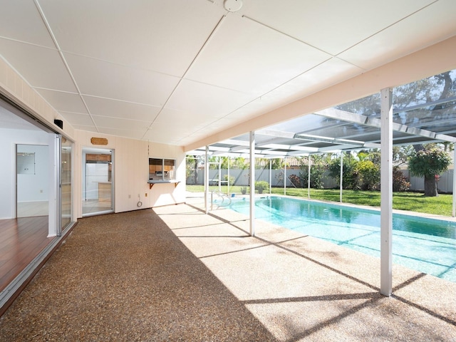 view of swimming pool with glass enclosure, a patio, and a fenced in pool
