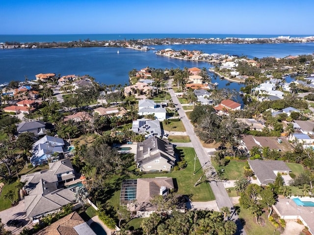 birds eye view of property with a water view and a residential view