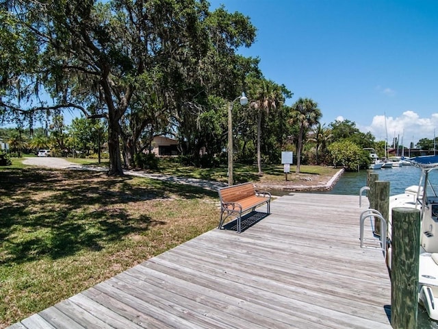 dock area featuring a water view and a yard