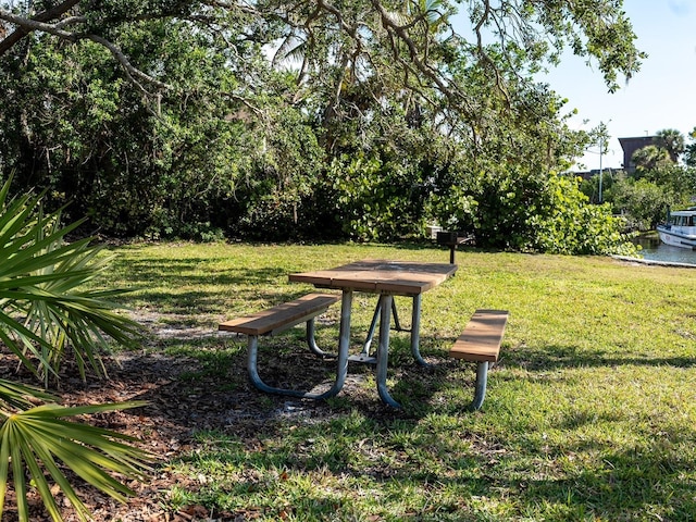 view of property's community with a yard and a water view