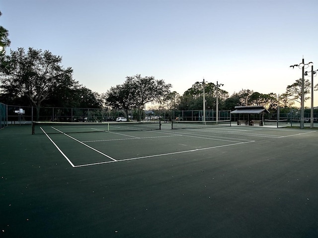 view of tennis court with fence