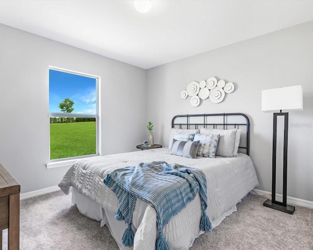 bedroom featuring carpet and baseboards