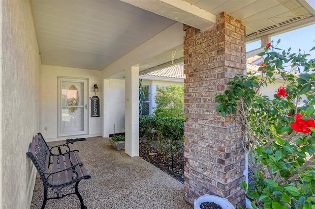 view of exterior entry featuring brick siding