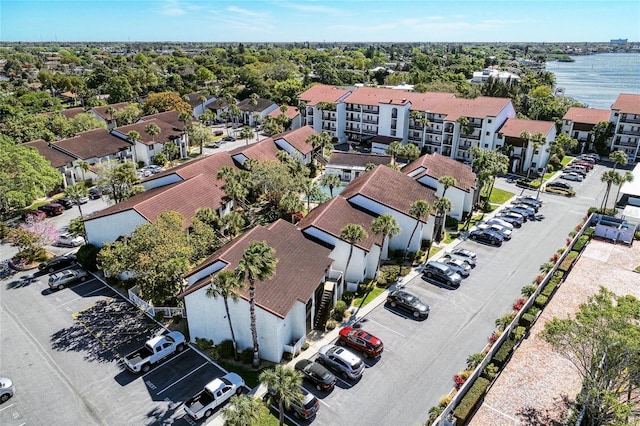 birds eye view of property with a water view and a residential view