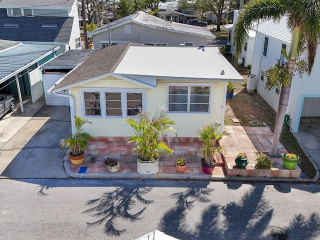 exterior space featuring concrete driveway and a patio