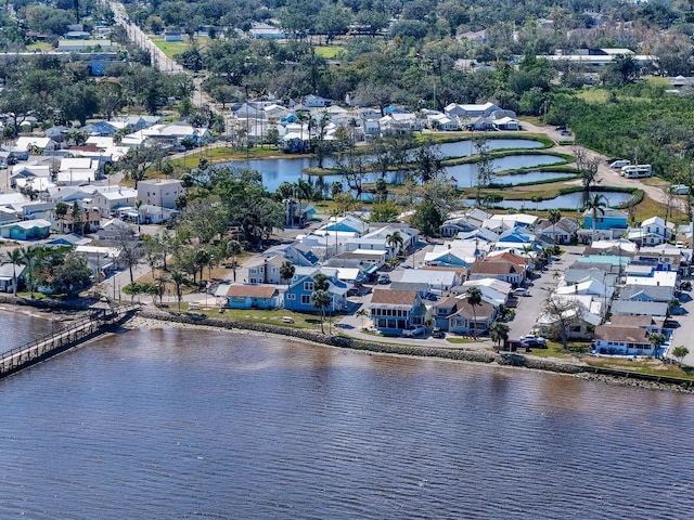 drone / aerial view featuring a residential view and a water view