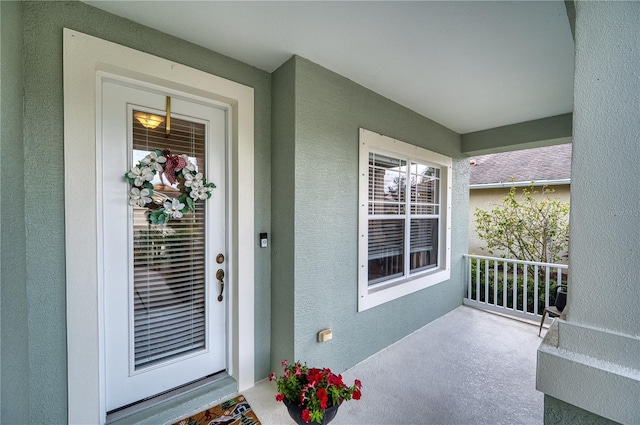 property entrance with stucco siding