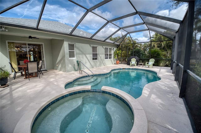 view of swimming pool with a ceiling fan, a lanai, a patio area, and a pool with connected hot tub