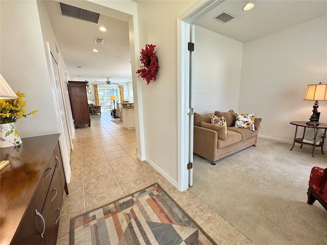 hallway featuring light carpet, visible vents, and recessed lighting