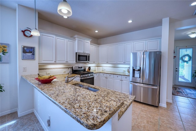 kitchen featuring stainless steel appliances, a peninsula, and white cabinets