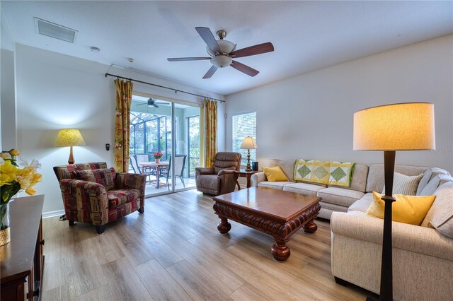 living area with light wood-type flooring and a ceiling fan