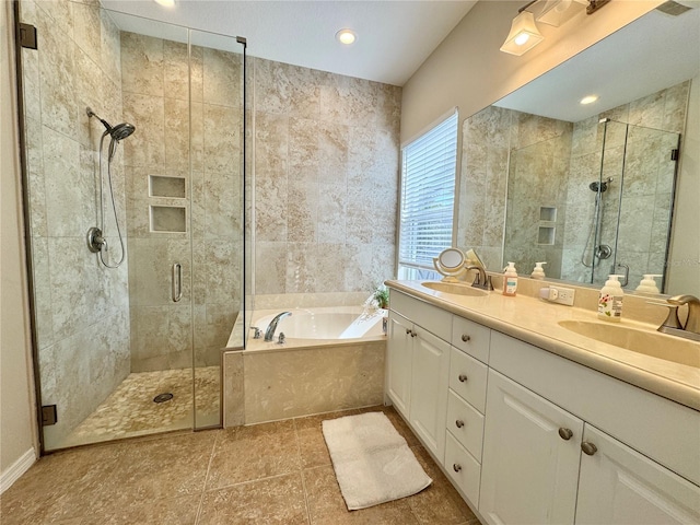 full bathroom with double vanity, a garden tub, a shower stall, and a sink