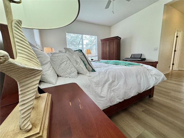 bedroom with a ceiling fan and wood finished floors