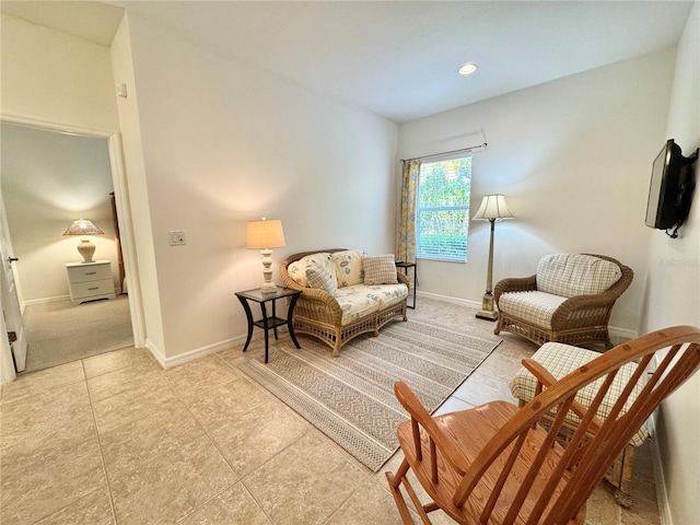 sitting room featuring baseboards and light tile patterned flooring