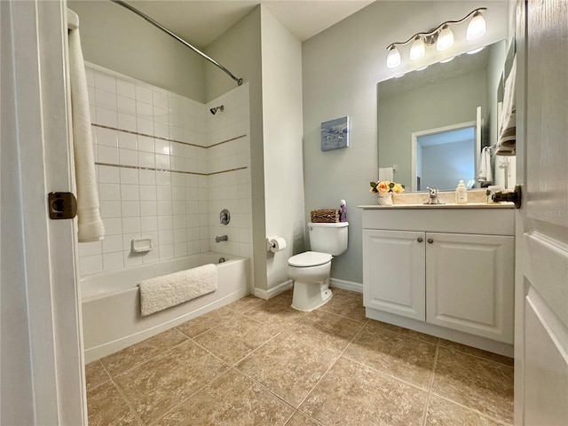 bathroom with bathtub / shower combination, toilet, vanity, baseboards, and tile patterned floors