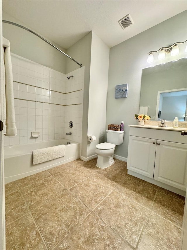 bathroom with baseboards, visible vents, toilet, vanity, and washtub / shower combination