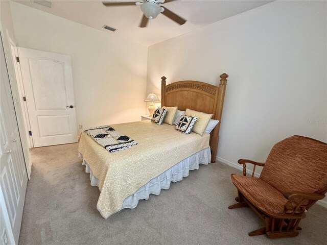 bedroom with light colored carpet, visible vents, and ceiling fan