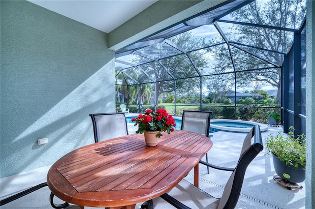 view of patio with glass enclosure and an in ground hot tub