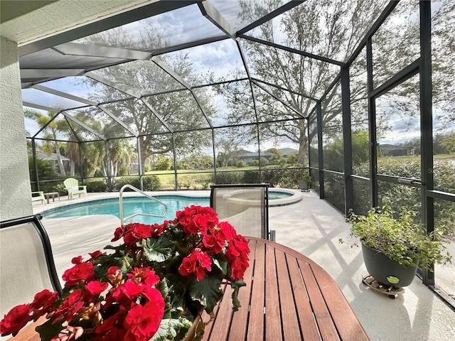 outdoor pool with a patio, a lanai, and a hot tub