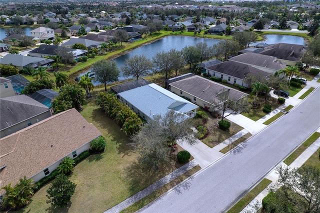 drone / aerial view with a water view and a residential view