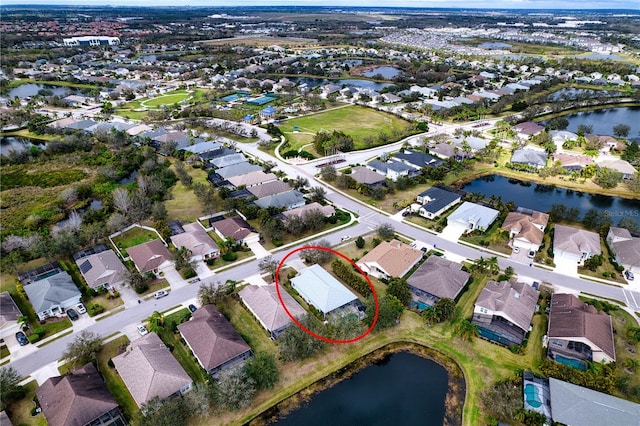 birds eye view of property featuring a water view and a residential view