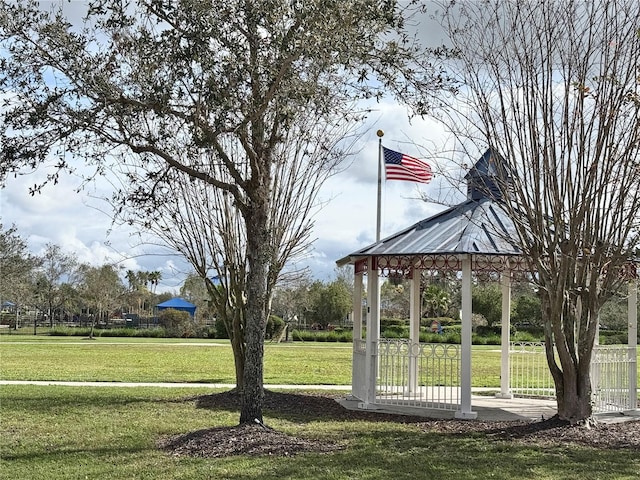 surrounding community featuring a gazebo and a lawn