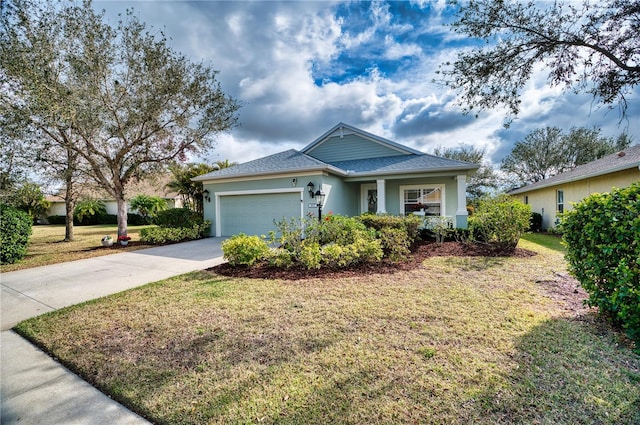 view of front of property with a garage, a front yard, concrete driveway, and stucco siding