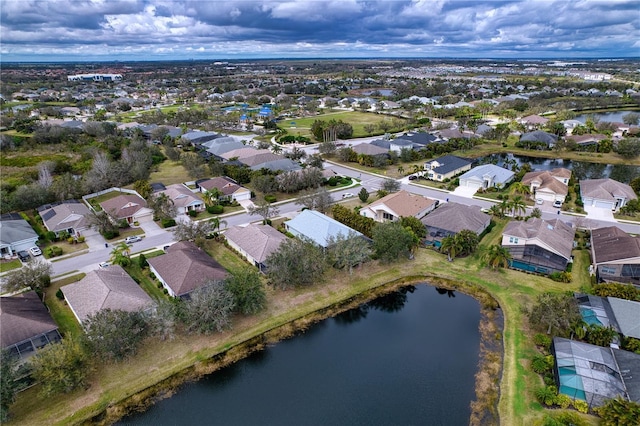 drone / aerial view with a water view and a residential view