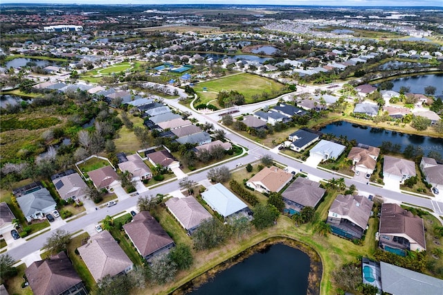 drone / aerial view featuring a water view and a residential view