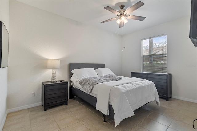 bedroom featuring a ceiling fan, light tile patterned flooring, and baseboards