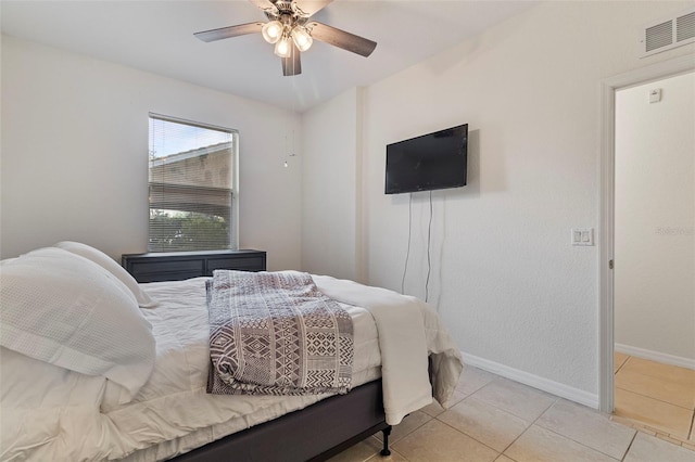 bedroom featuring light tile patterned floors, ceiling fan, visible vents, and baseboards