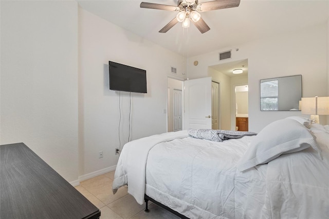 bedroom featuring visible vents, a ceiling fan, light tile patterned flooring, ensuite bath, and baseboards