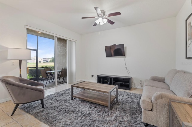 tiled living room with a ceiling fan and baseboards