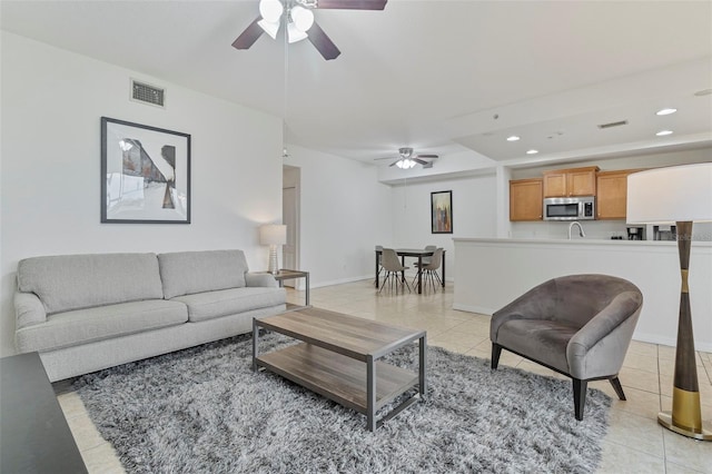 living area with light tile patterned floors, recessed lighting, a ceiling fan, baseboards, and visible vents