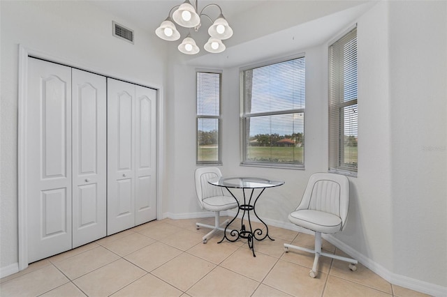 dining room featuring light tile patterned floors, baseboards, visible vents, and an inviting chandelier