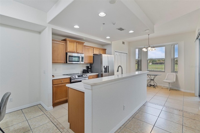 kitchen featuring light tile patterned floors, appliances with stainless steel finishes, light countertops, and brown cabinetry