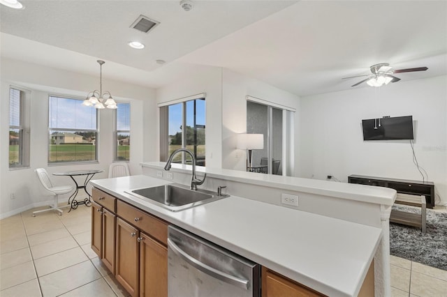 kitchen featuring dishwasher, visible vents, brown cabinets, and a sink