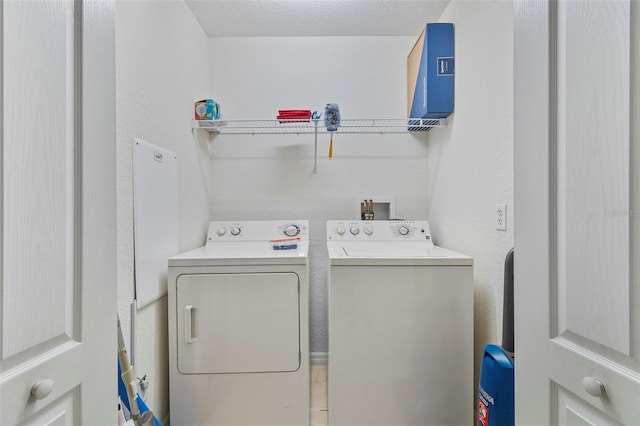 clothes washing area featuring laundry area and washing machine and clothes dryer