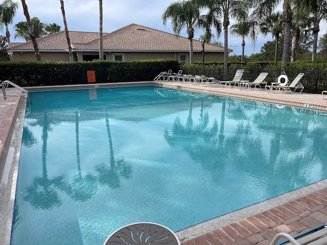 pool featuring fence and a patio