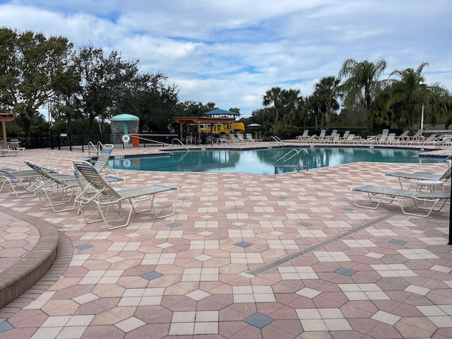 pool featuring a patio area and fence