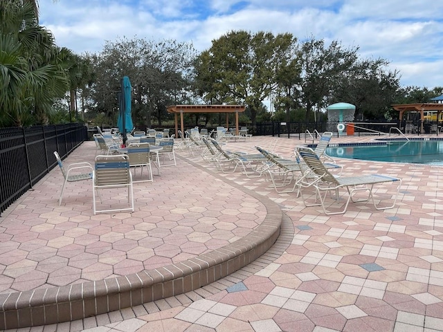 pool with a patio area, fence, and a pergola