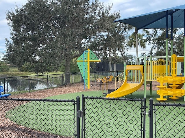 communal playground featuring a gate and fence