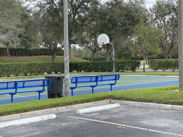 view of basketball court with community basketball court and a yard