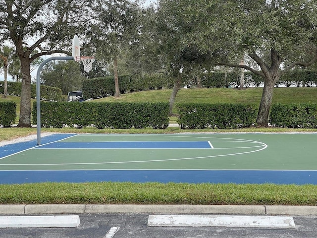 view of basketball court with community basketball court and a yard