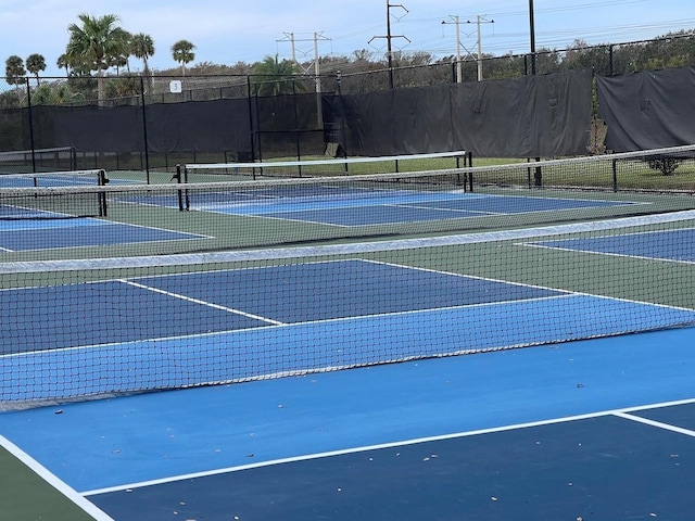 view of tennis court featuring fence