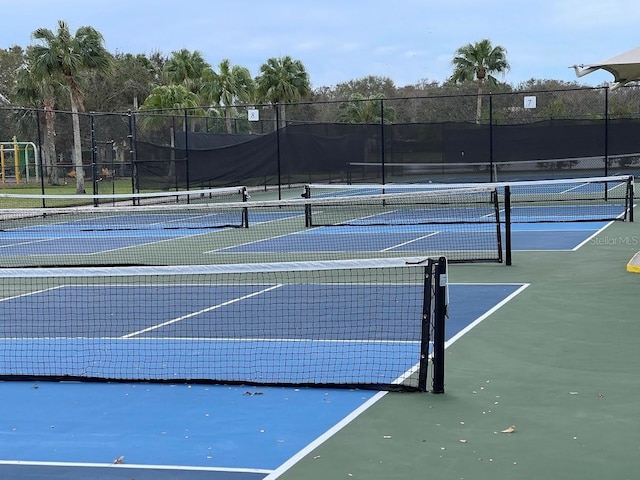 view of sport court featuring fence